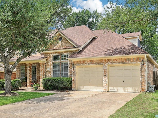 14928 Thatcher Dr, Austin, TX 78717 - view of front of home featuring a garage, driveway, a shingled roof, and brick siding