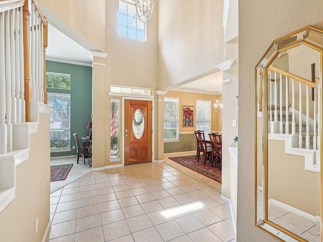 14928 Thatcher Dr, Austin, TX 78717 - entryway featuring a towering ceiling, a chandelier, stairway, light tile patterned floors, and baseboards