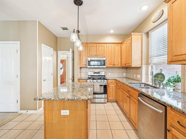 14928 Thatcher Dr, Austin, TX 78717 - kitchen featuring appliances with stainless steel finishes, a sink, light tile patterned floors, and decorative backsplash