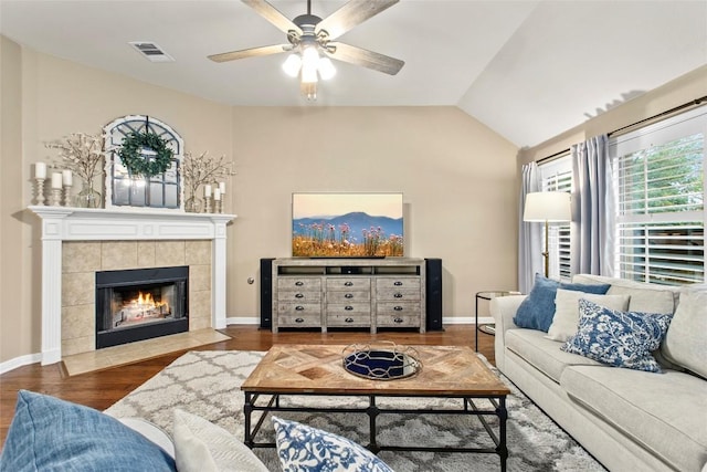 240 Maeves Way, Austin, TX 78737 - living area with a ceiling fan, wood finished floors, lofted ceiling, a tile fireplace, and baseboards