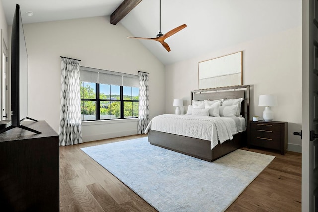 bedroom with beamed ceiling, wood finished floors, high vaulted ceiling, and a ceiling fan
