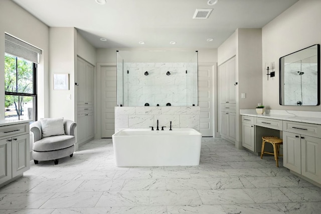 811 Wade Rd, New Braunfels, TX 78132 - bathroom featuring marble finish floors, vanity, a soaking tub, a marble finish shower, and recessed lighting