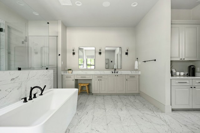 811 Wade Rd, New Braunfels, TX 78132 - bathroom featuring a stall shower, marble finish flooring, a freestanding bath, vanity, and baseboards