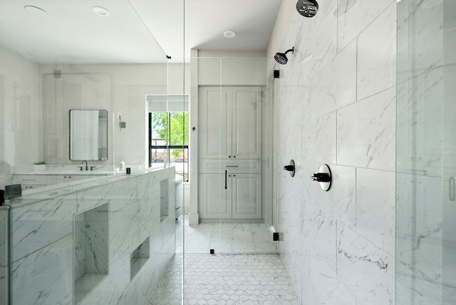 bathroom featuring a marble finish shower and vanity