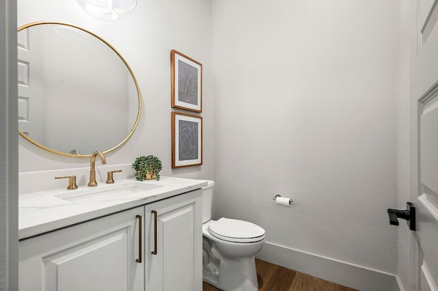 811 Wade Rd, New Braunfels, TX 78132 - half bath featuring vanity, wood finished floors, toilet, and baseboards