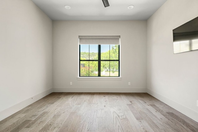 empty room featuring light wood-style flooring and baseboards