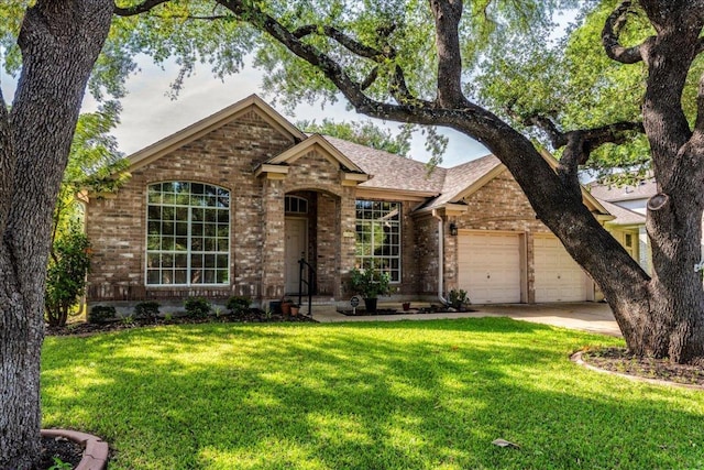 view of front facade featuring brick siding, a front lawn, and an attached garage