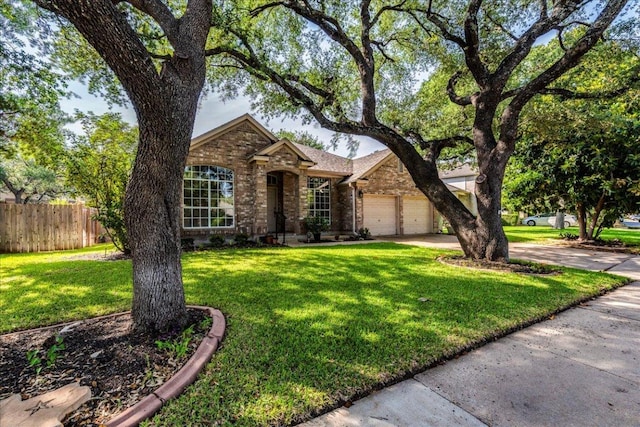 traditional-style house with brick siding, driveway, and an attached garage