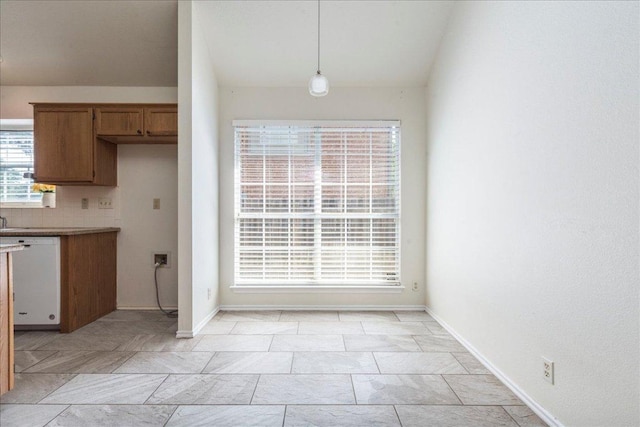1302 Roadrunner Dr, Cedar Park, TX 78613 - kitchen featuring dishwasher, hanging light fixtures, baseboards, brown cabinets, and light countertops