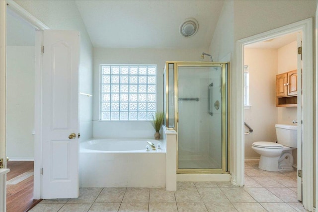 bathroom with a stall shower, a garden tub, toilet, and tile patterned flooring