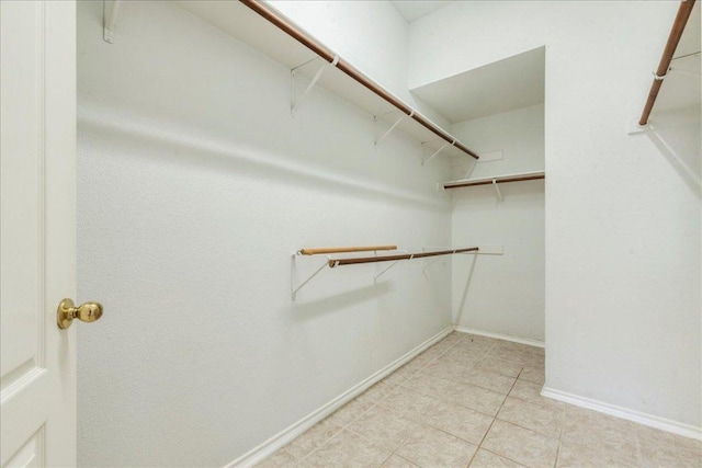 spacious closet with light tile patterned flooring
