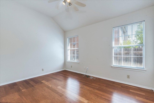 spare room featuring ceiling fan, hardwood / wood-style flooring, baseboards, and lofted ceiling