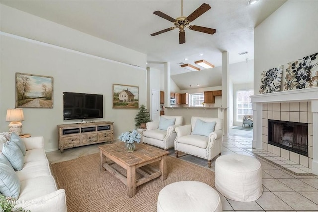 1302 Roadrunner Dr, Cedar Park, TX 78613 - living area featuring ceiling fan, lofted ceiling, a tile fireplace, and light tile patterned floors