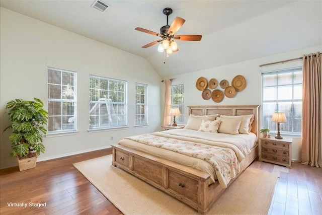 1302 Roadrunner Dr, Cedar Park, TX 78613 - bedroom featuring multiple windows, light wood-style floors, lofted ceiling, and baseboards