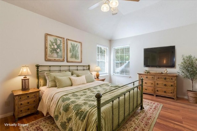 1302 Roadrunner Dr, Cedar Park, TX 78613 - bedroom with wood finished floors, baseboards, lofted ceiling, and a ceiling fan
