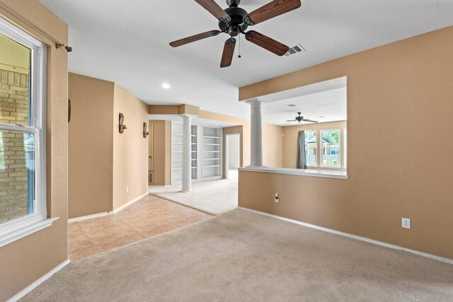 empty room featuring ornate columns, a ceiling fan, carpet flooring, baseboards, and recessed lighting