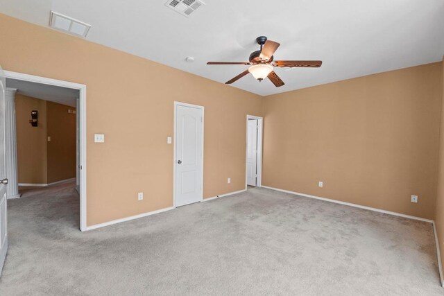 unfurnished bedroom with light colored carpet, baseboards, and a ceiling fan