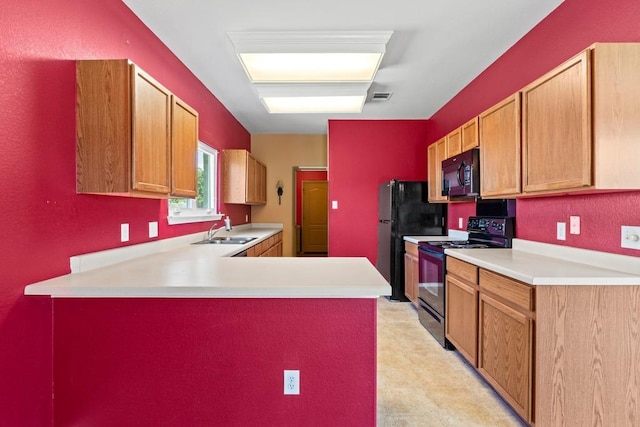 109 Silver Lace Ln, Round Rock, TX 78664 - kitchen featuring black appliances, a sink, light countertops, a peninsula, and light floors