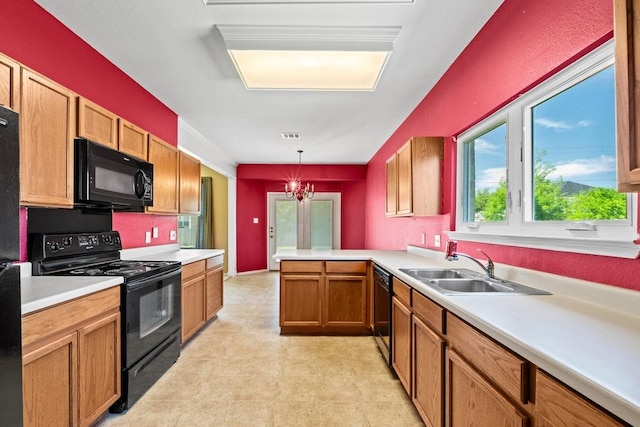kitchen featuring black appliances, light flooring, light countertops, a peninsula, and a sink