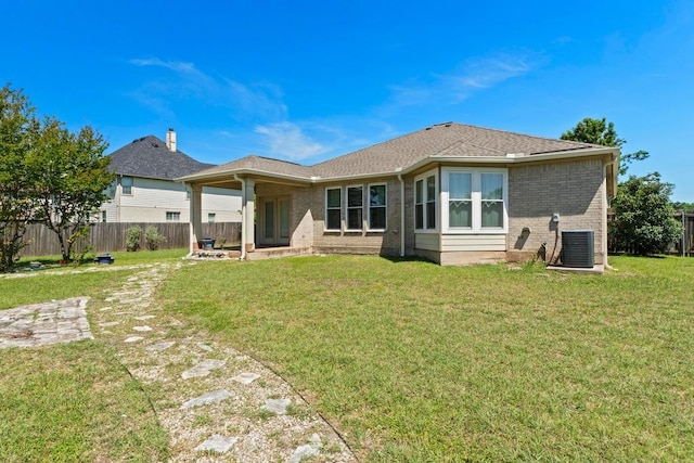 109 Silver Lace Ln, Round Rock, TX 78664 - rear view of property with brick siding, central AC unit, and a patio