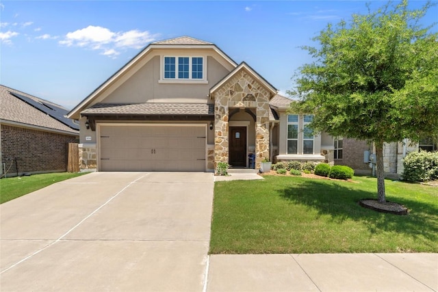 view of front of home featuring stucco siding, concrete driveway, stone siding, a front yard, and an attached garage