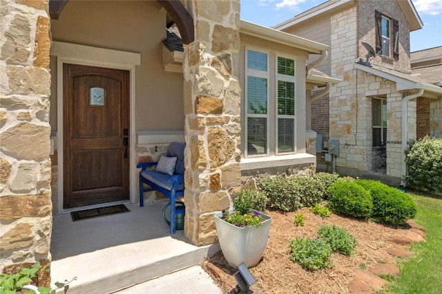 doorway to property featuring stone siding