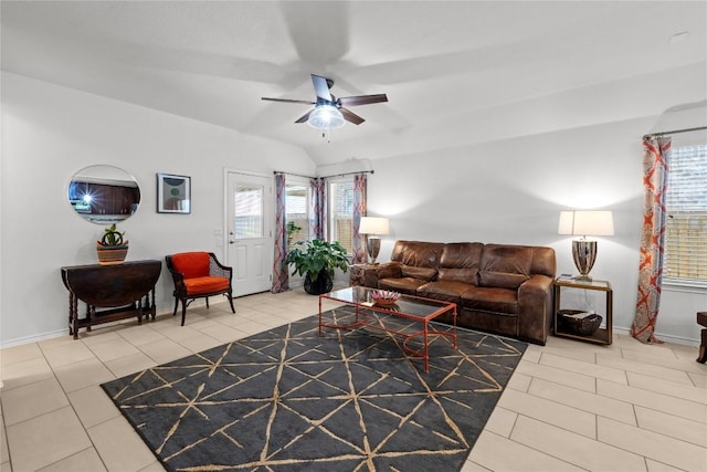 living room with ceiling fan, tile patterned floors, baseboards, and vaulted ceiling