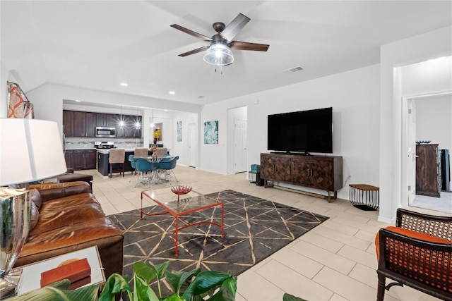 living area featuring a ceiling fan, light tile patterned floors, and recessed lighting