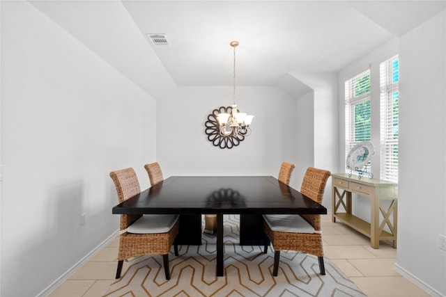 dining room with a chandelier, light tile patterned floors, and baseboards