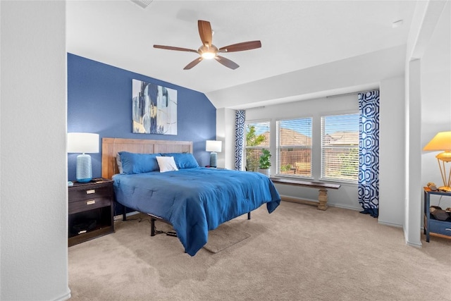 bedroom with carpet floors, lofted ceiling, baseboards, and a ceiling fan