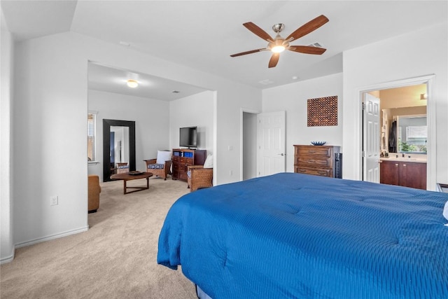 bedroom with carpet flooring, baseboards, a ceiling fan, and ensuite bath
