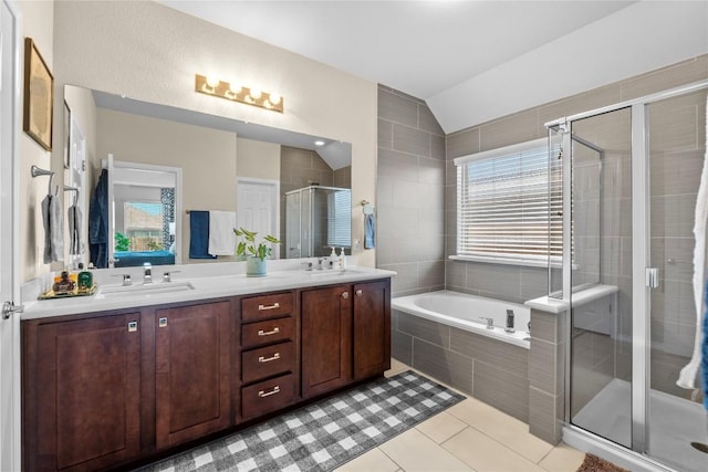 bathroom featuring a shower stall, a garden tub, double vanity, tile patterned floors, and healthy amount of natural light