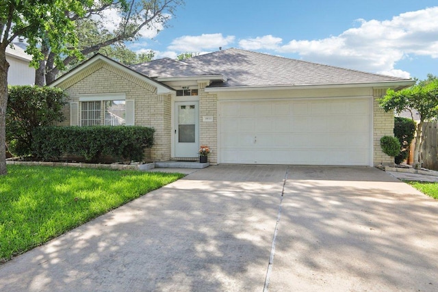 3933 Kristencreek Ln, Round Rock, TX 78681 - ranch-style house featuring brick siding, concrete driveway, a garage, and a front lawn