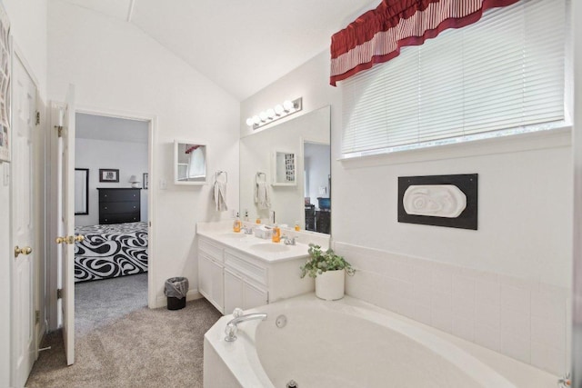 3933 Kristencreek Ln, Round Rock, TX 78681 - bathroom with connected bathroom, a bath, vanity, and lofted ceiling