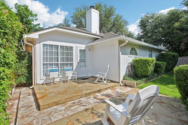 3933 Kristencreek Ln, Round Rock, TX 78681 - back of house featuring a patio area and a chimney