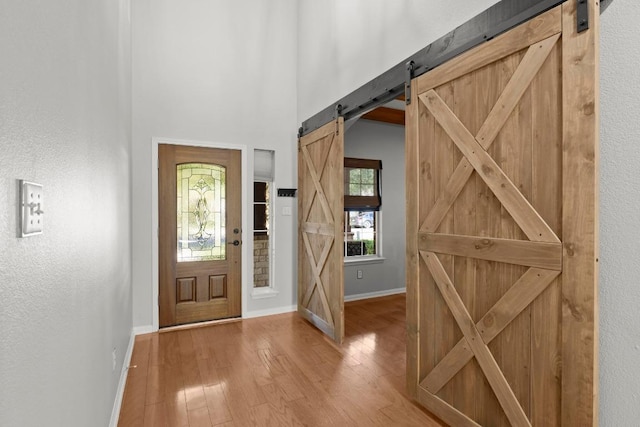 426 Valona Loop, Round Rock, TX 78681 - foyer entrance featuring a barn door and wood finished floors