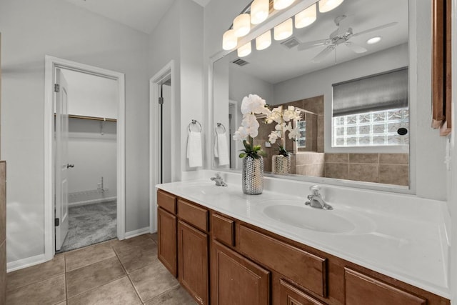 426 Valona Loop, Round Rock, TX 78681 - full bathroom featuring double vanity, tile patterned flooring, a spacious closet, ceiling fan, and tiled shower