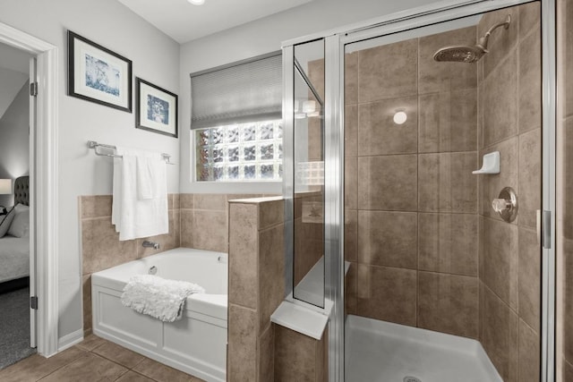 426 Valona Loop, Round Rock, TX 78681 - ensuite bathroom with a garden tub, a shower stall, and tile patterned flooring