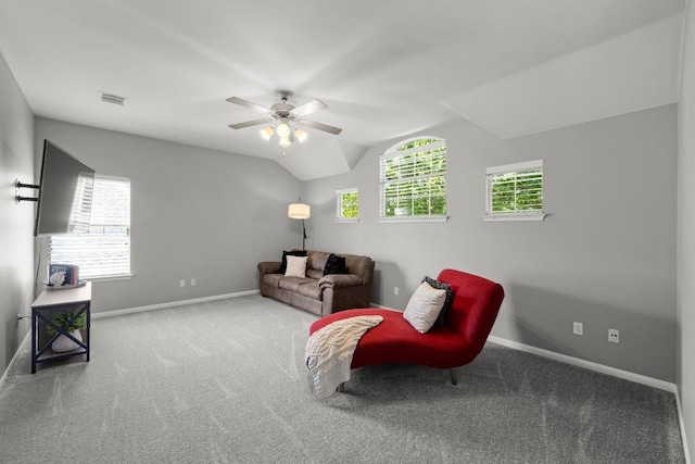 living area with carpet, baseboards, ceiling fan, and lofted ceiling