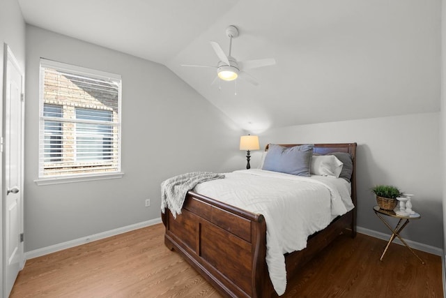 426 Valona Loop, Round Rock, TX 78681 - bedroom with lofted ceiling, wood finished floors, and a ceiling fan