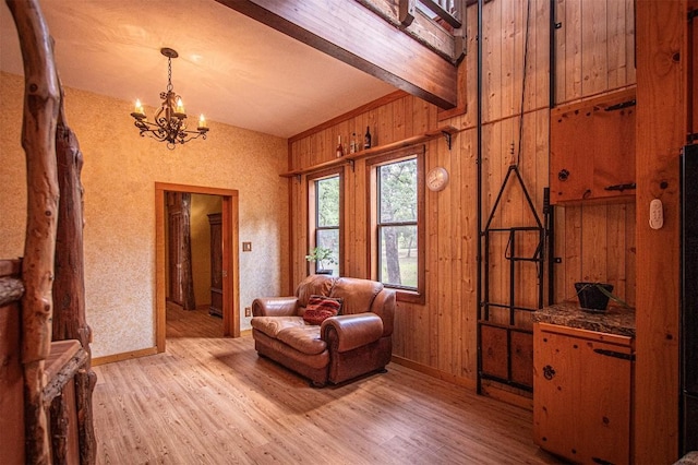 914 Sand Hills Rd, Red Rock, TX 78662 - living area with light wood-type flooring, a chandelier, wood walls, and baseboards
