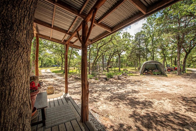 914 Sand Hills Rd, Red Rock, TX 78662 - wooden terrace featuring view of wooded area