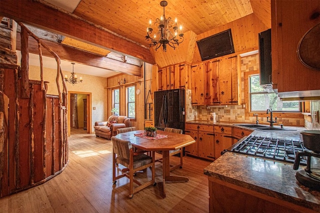 914 Sand Hills Rd, Red Rock, TX 78662 - kitchen featuring a chandelier, a sink, freestanding refrigerator, light wood-style flooring, and dark countertops