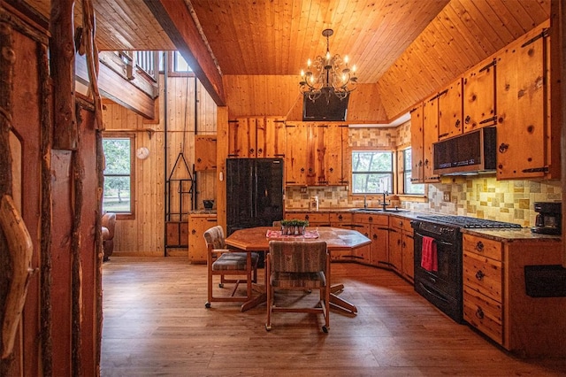 914 Sand Hills Rd, Red Rock, TX 78662 - kitchen with black appliances, wood ceiling, a chandelier, brown cabinets, and light wood-style flooring