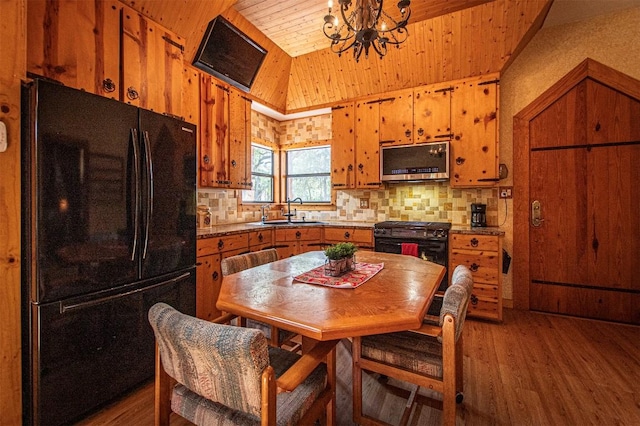 914 Sand Hills Rd, Red Rock, TX 78662 - kitchen featuring black appliances, a sink, wood ceiling, brown cabinets, and vaulted ceiling