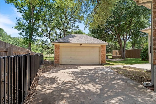 detached garage featuring fence