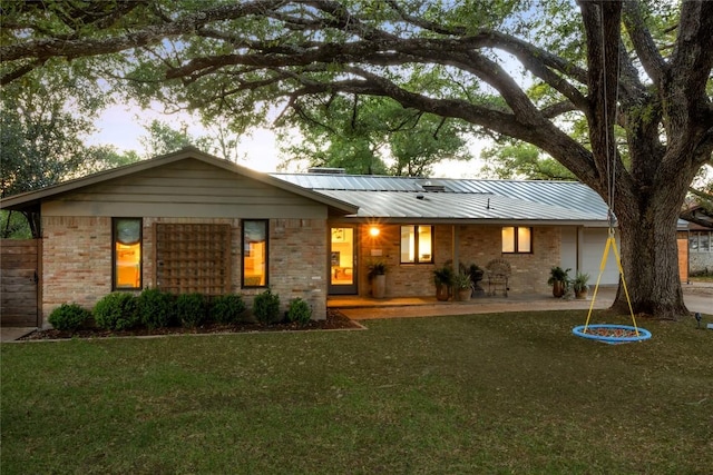 4504 Erin Ln, Austin, TX 78756 - view of front of property with covered porch, a front lawn, brick siding, and metal roof
