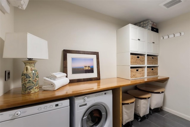 4504 Erin Ln, Austin, TX 78756 - clothes washing area with washing machine and dryer, cabinet space, baseboards, and dark tile patterned flooring