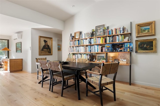4504 Erin Ln, Austin, TX 78756 - dining area with light wood finished floors, baseboards, and a wall mounted air conditioner