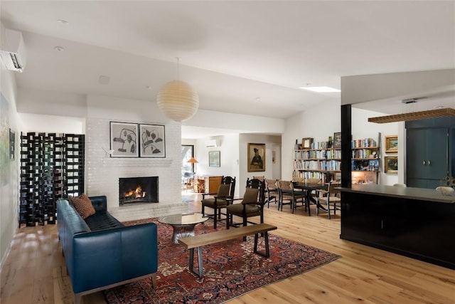 4504 Erin Ln, Austin, TX 78756 - living room featuring wood finished floors, a wall unit AC, and a fireplace
